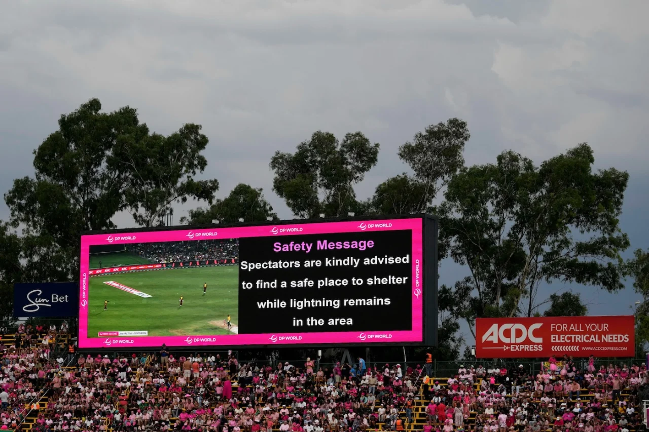 Stadium LED scoreboard, crowd dressed in pink